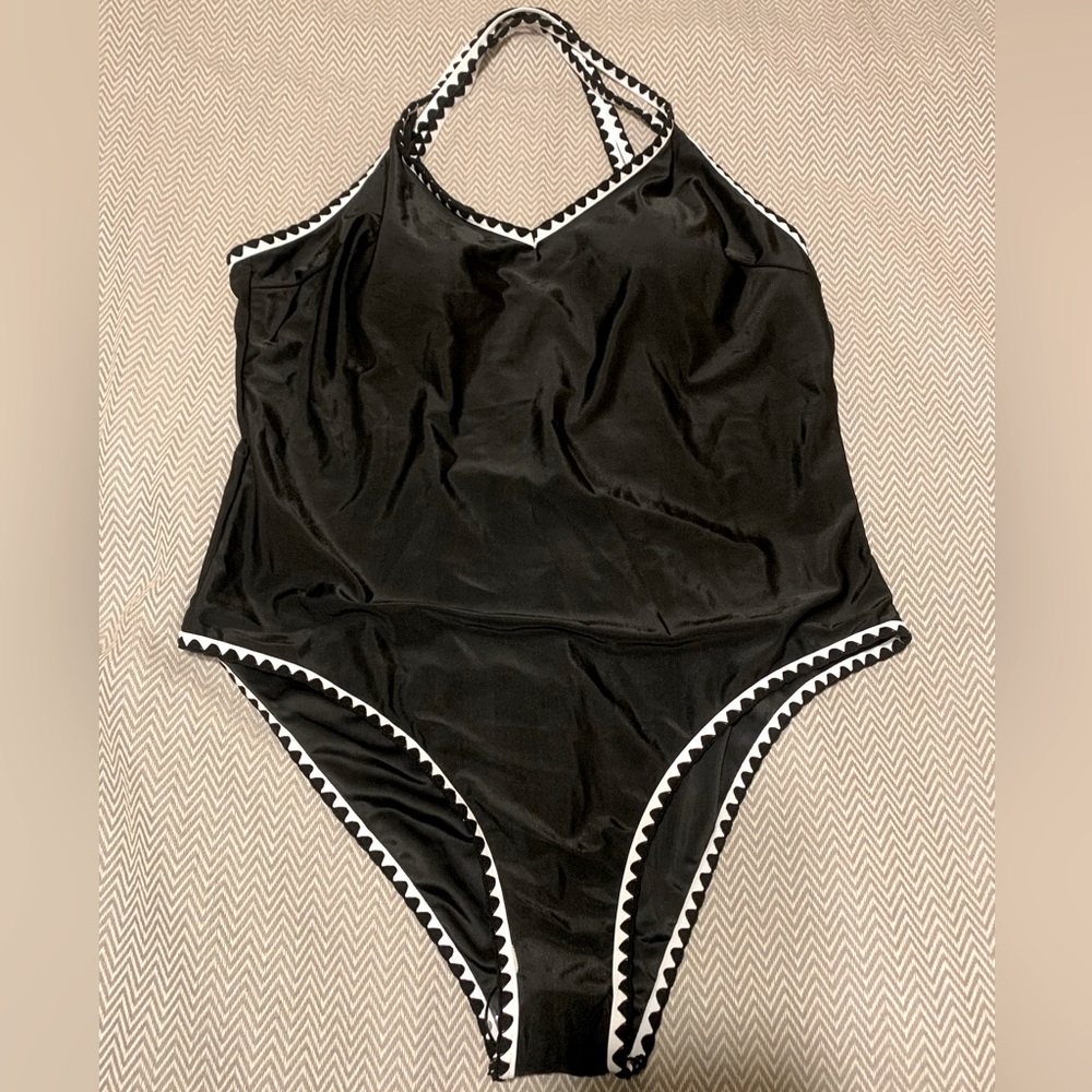 NWT. SHEIN one piece swimsuit. Black with white trim. Criss-cross back straps.